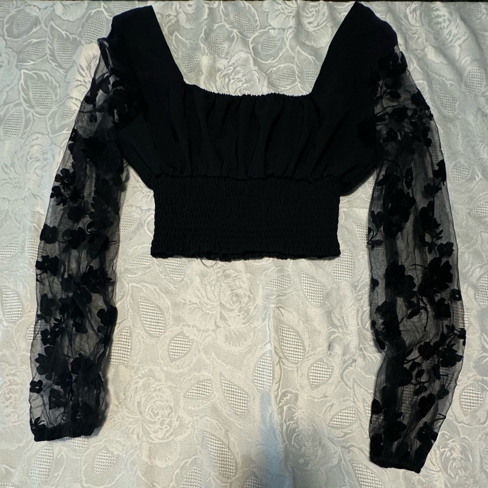 All black with mesh lining and flowers on the side